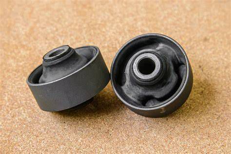 Close-up of a worn suspension bush next to a new replacement bush